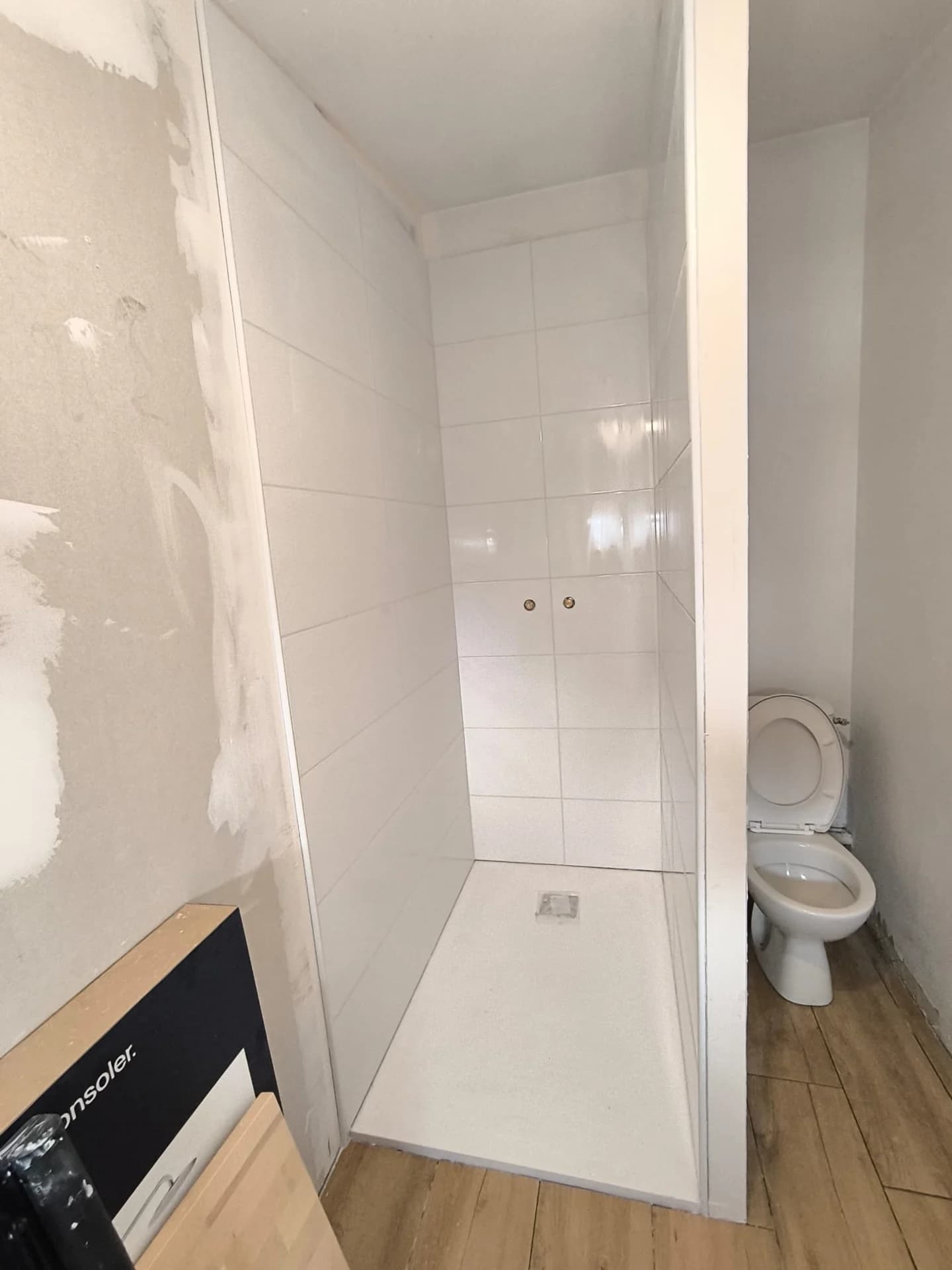 Douche blanche et travaux de cloisonnement dans une pièce d’eau